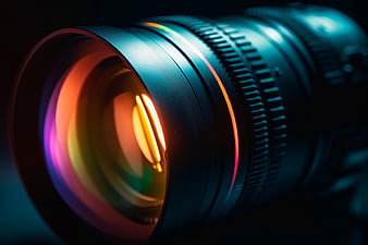 Close-up of camera lens with colorful reflections and bokeh