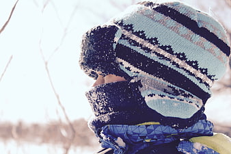 Child in Winter Hat and Scarf in Snowy Landscape