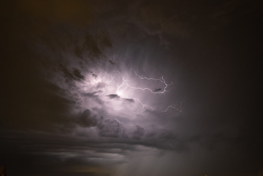 Dramatic Lightning Strike Illuminating Dark Storm Clouds at Night