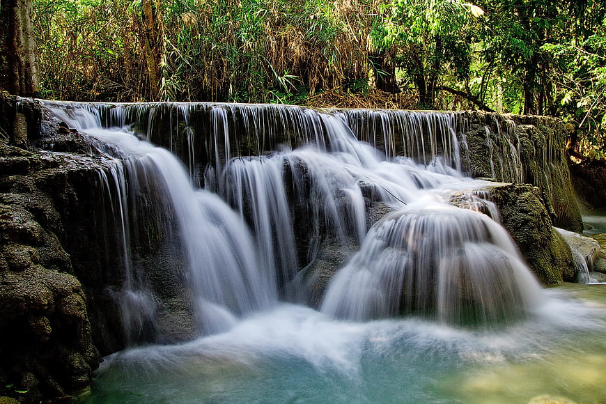 Serene cascading waterfall in lush tropical forest