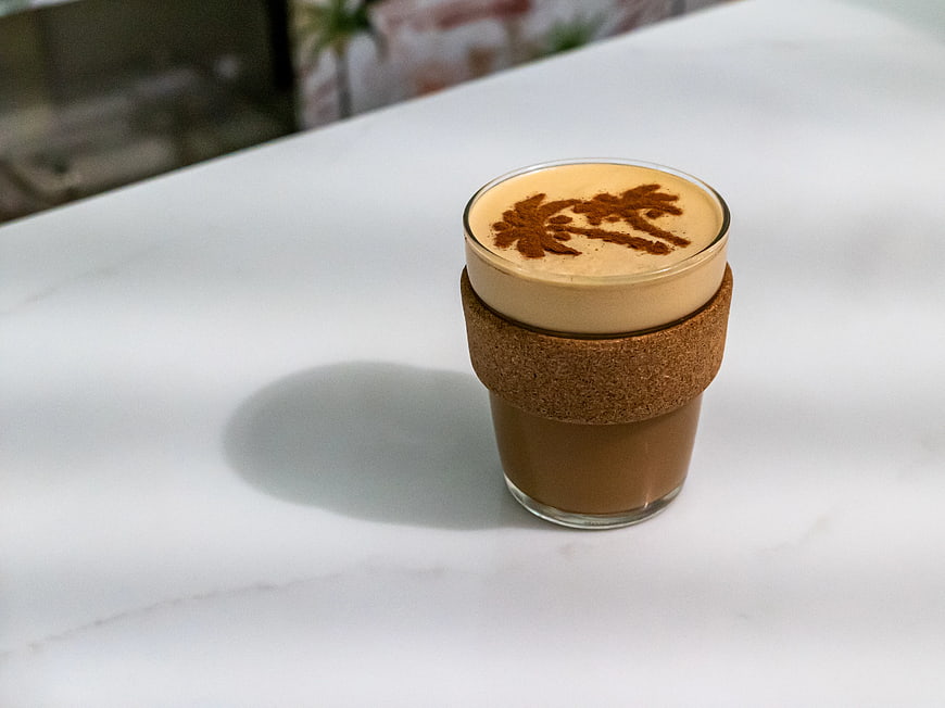 Cortado Coffee with Palm Tree Latte Art on White Table