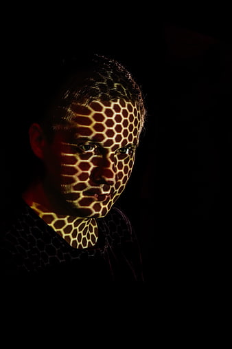 Portrait of man with honeycomb light pattern on face