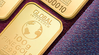Gold bars on textured blue fabric background