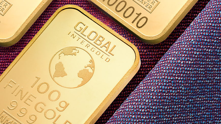 Gold bars on textured blue fabric background