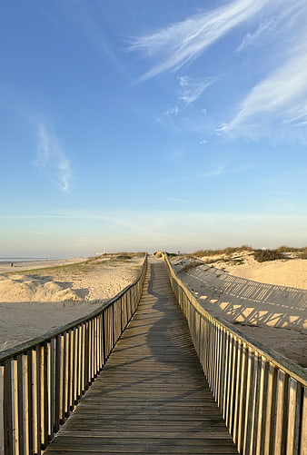 Wooden Boardwalk Path Through Sand Dunes to Beach