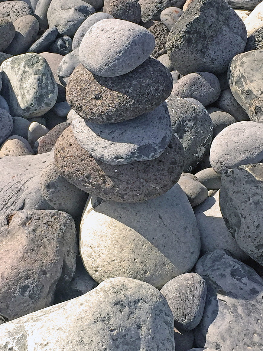 Stacked Beach Stones Tower on Rocky Shore