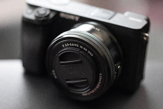 Close-up of black Sony mirrorless camera with lens cap