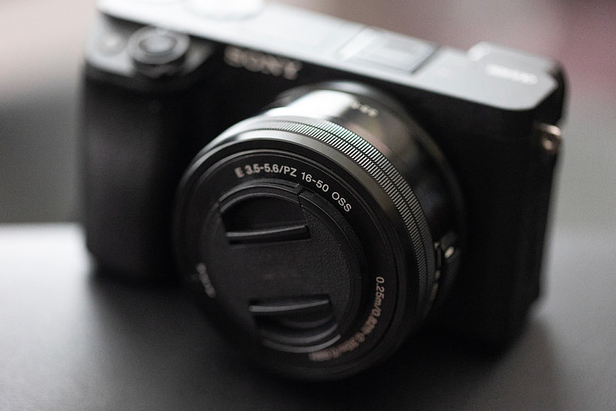 Close-up of black Sony mirrorless camera with lens cap