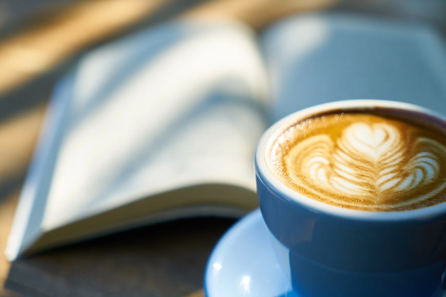 Blue Coffee Cup with Latte Art and Open Book