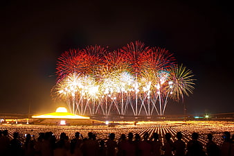 Spectacular Fireworks Display Over Stadium Crowd at Night