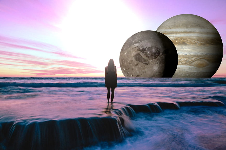 Woman Silhouette on Beach with Giant Planets in Sunset Sky