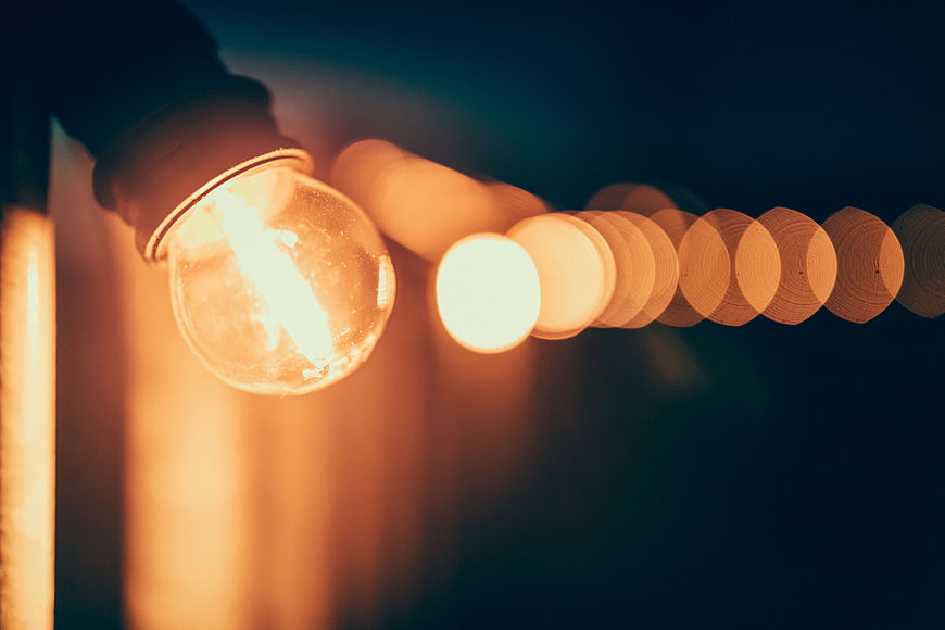 Close-up of glowing vintage light bulb with bokeh background