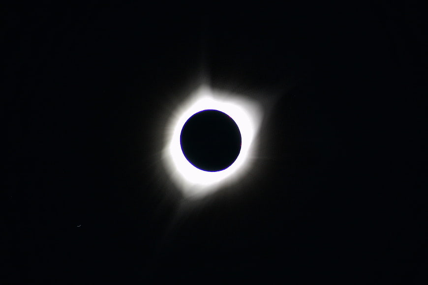 Total Solar Eclipse with Visible Corona in Black Sky