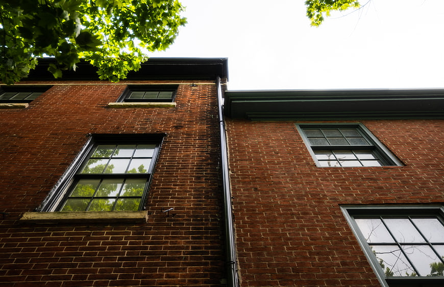 Low Angle View of Red Brick Building Facade with Windows