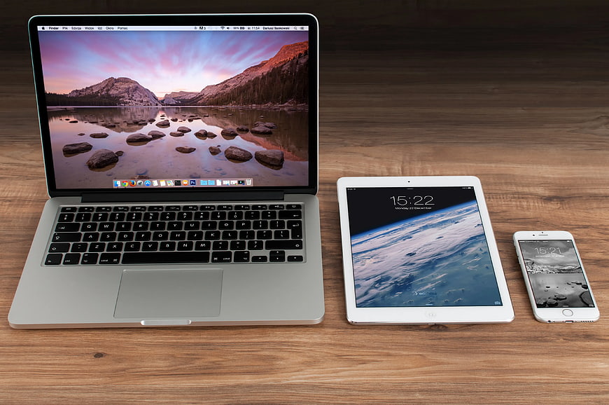 MacBook Pro, iPad, and iPhone on Wooden Desk