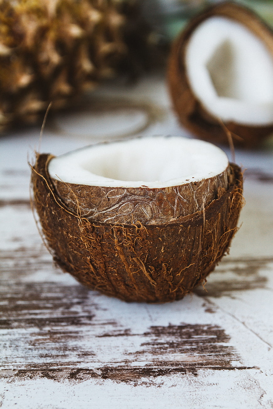 Fresh Coconut Half on Rustic White Wooden Table