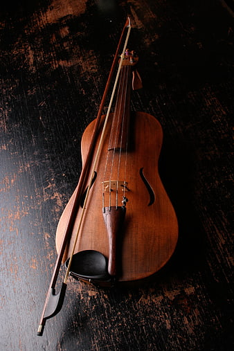 Vintage Violin and Bow on Dark Textured Wood Background