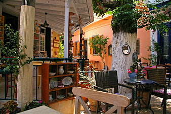Rustic Mediterranean Courtyard Cafe with Terracotta Walls and Greenery