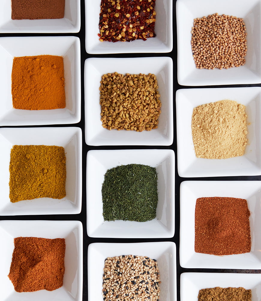 Top View of Various Spices in White Square Bowls