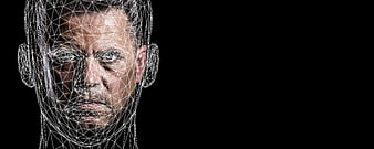 Man's face with digital wireframe overlay on black background