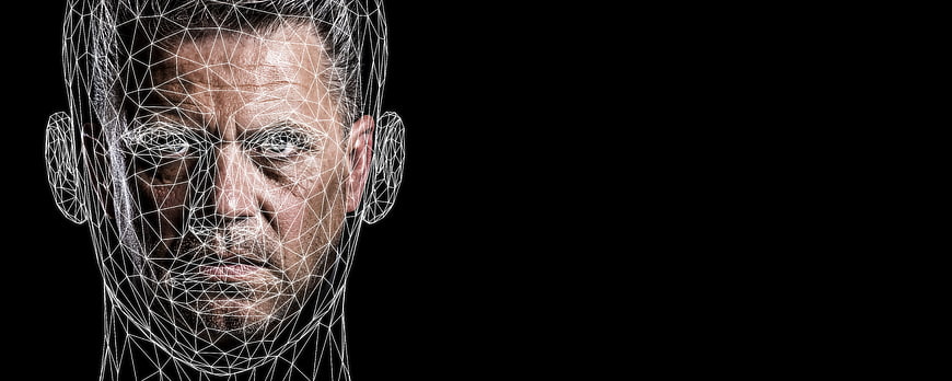 Man's face with digital wireframe overlay on black background