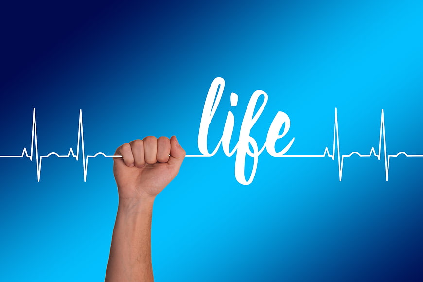 Hand holding white thread with life text and heartbeat line on blue background