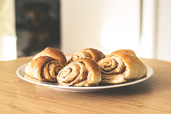 Freshly Baked Cinnamon Rolls on Wooden Table