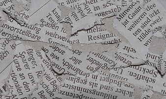 Torn German Newspaper Textures on Wall Background