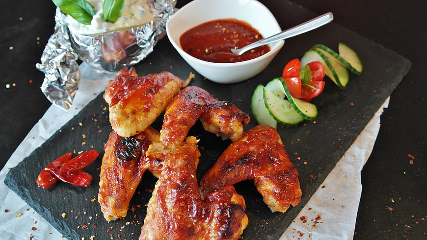 Spicy Grilled Chicken Wings with Dipping Sauce on Slate