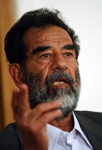 Close-up portrait of Saddam Hussein speaking