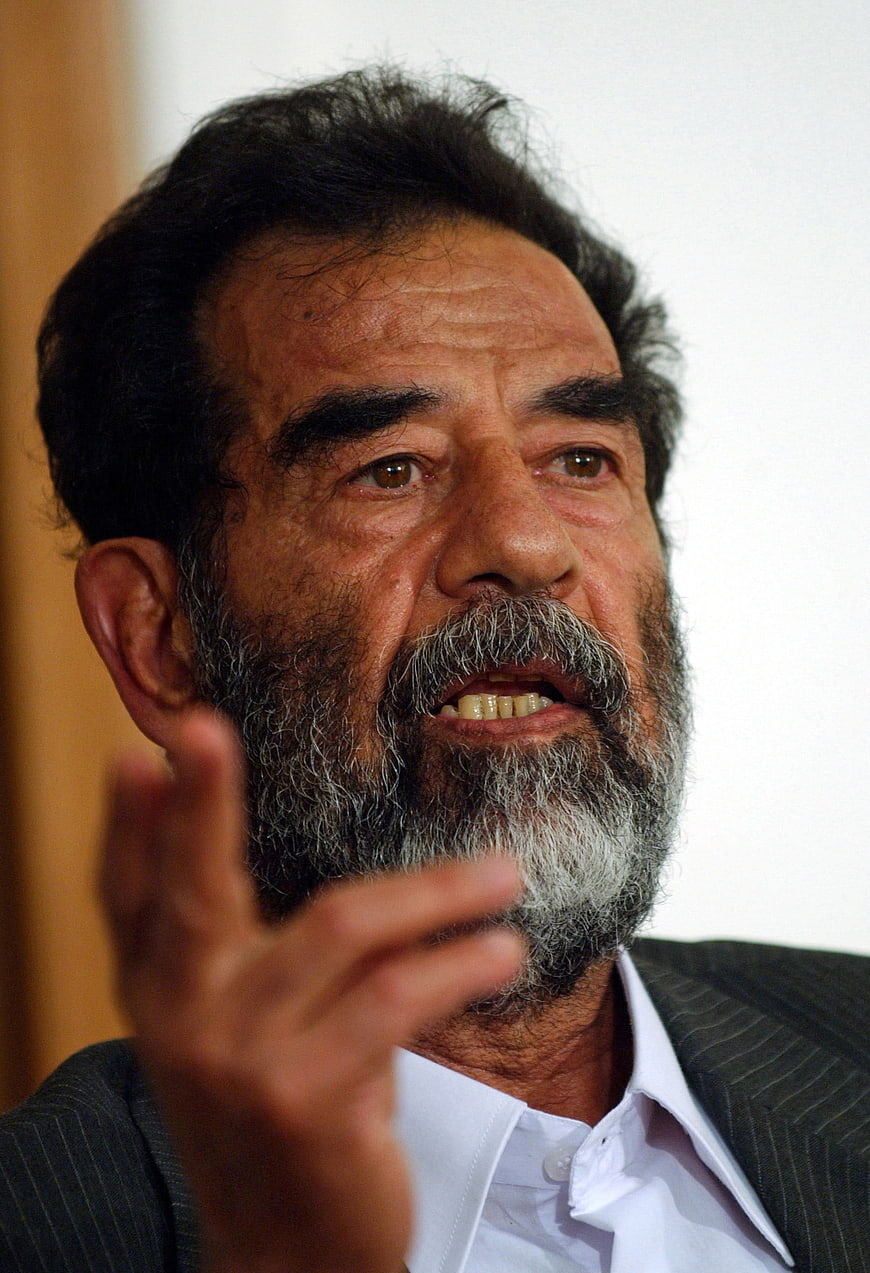 Close-up portrait of Saddam Hussein speaking