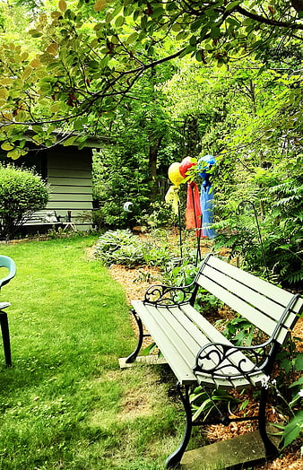Peaceful Garden Bench with Colorful Windsocks