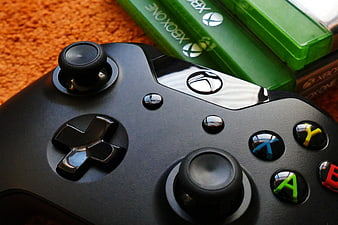 Close-up of Xbox Controller with Game Cases