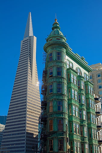 Transamerica Pyramid and historic green Victorian architecture in San Francisco
