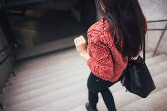 Woman in Red Sweater Walking Down Stairs