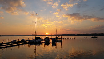 Serene Sunset Over Harbor With Docked Sailboats