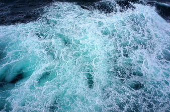 Aerial View of Turbulent Turquoise Ocean Waves and White Foam