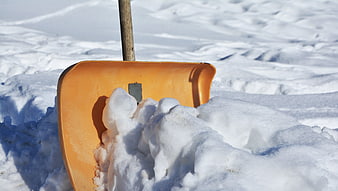 Orange Snow Shovel in Deep Snow