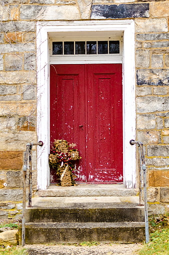 Vintage Red Wooden Door on Old Stone Building
