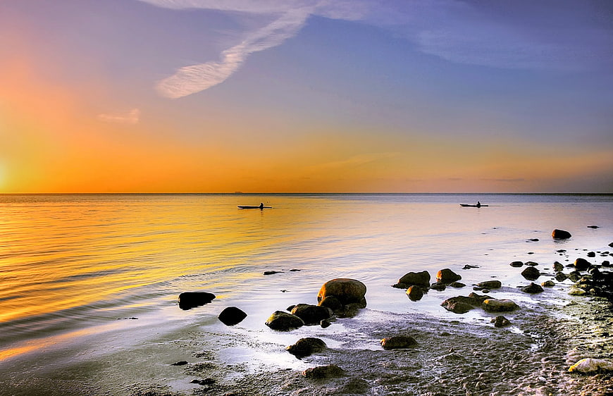 Serene Sunset Seascape with Kayaks on Calm Ocean