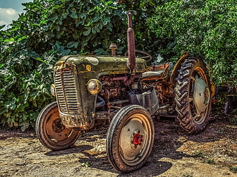 Vintage Rusty Green Tractor in Rural Farm Setting