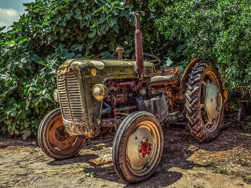 Vintage Rusty Green Tractor in Rural Farm Setting