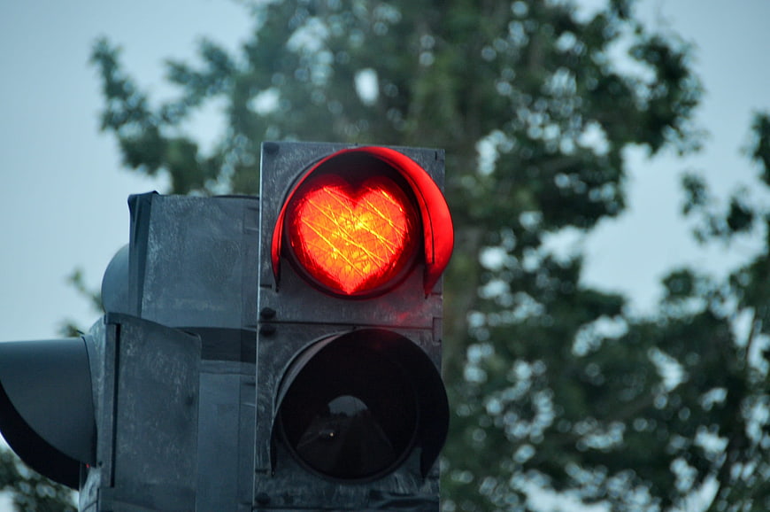 Red traffic light with heart shape symbol