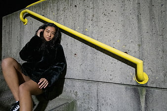 Asian Woman in Black Fur Coat Sitting on Concrete Stairs