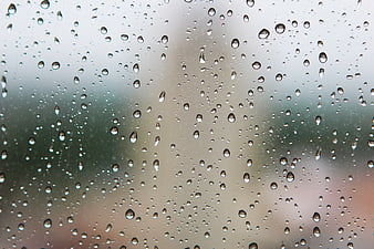 Raindrops on a Window Glass with Blurred Background
