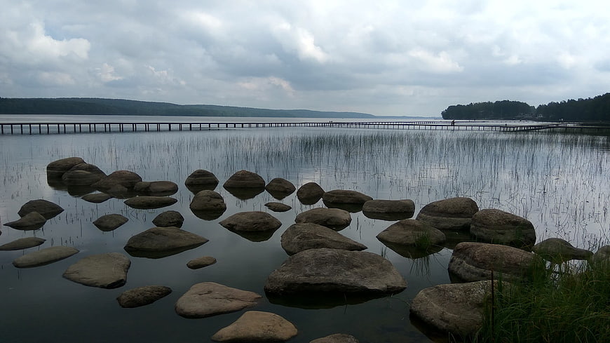 Serene Lake Landscape with Stepping Stones and Long Pier