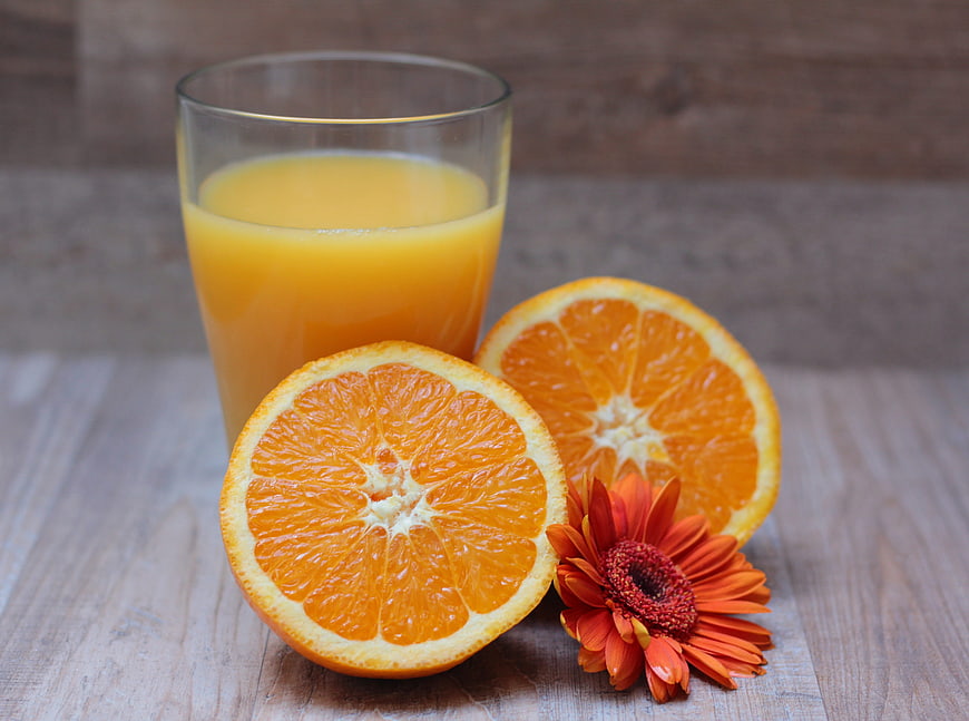 Fresh Orange Juice with Sliced Oranges and Gerbera Flower