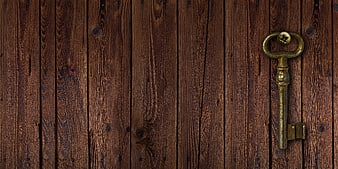 Vintage Brass Key On Dark Rustic Wooden Plank Background