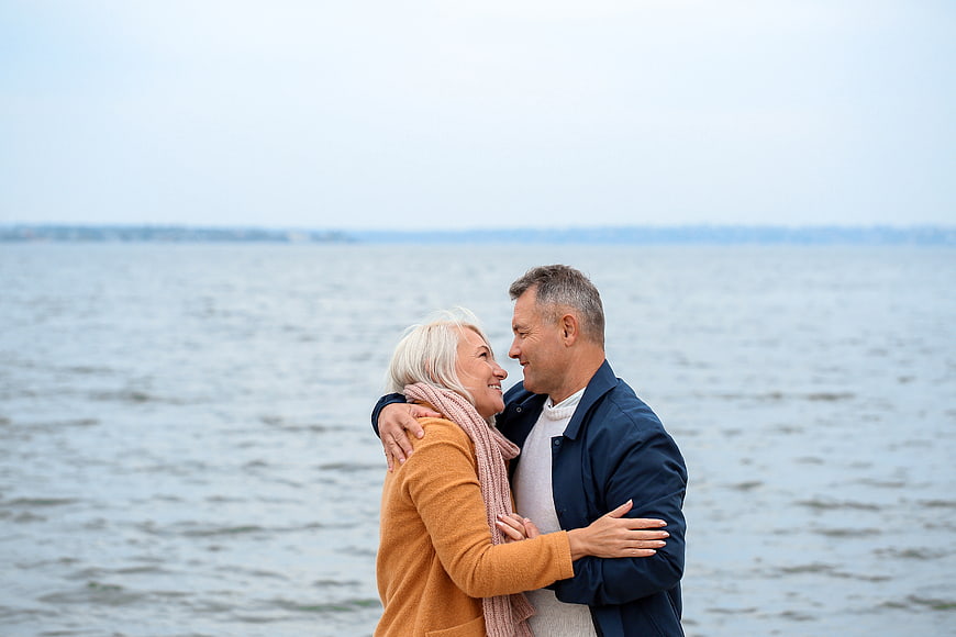 Happy Senior Couple Embracing by the Sea