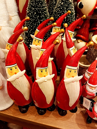 Hand-painted wooden Santa Claus figurines on a shelf